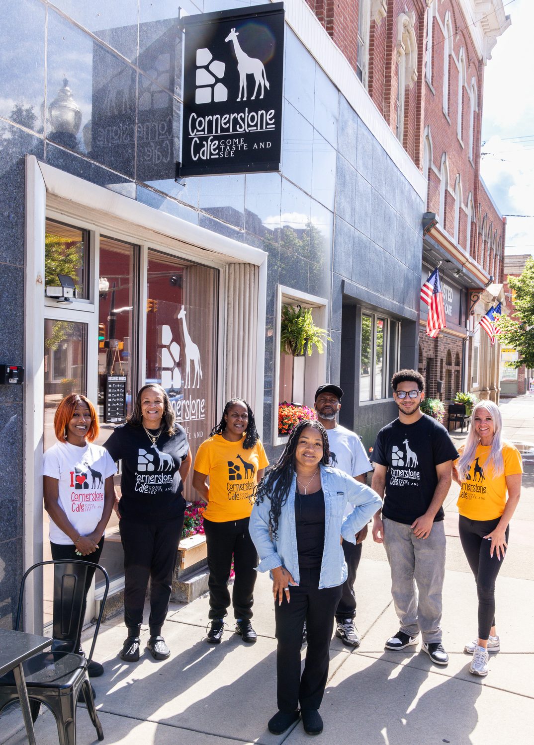 The Cornerstone Café team together outside the downtown Sharon storefront